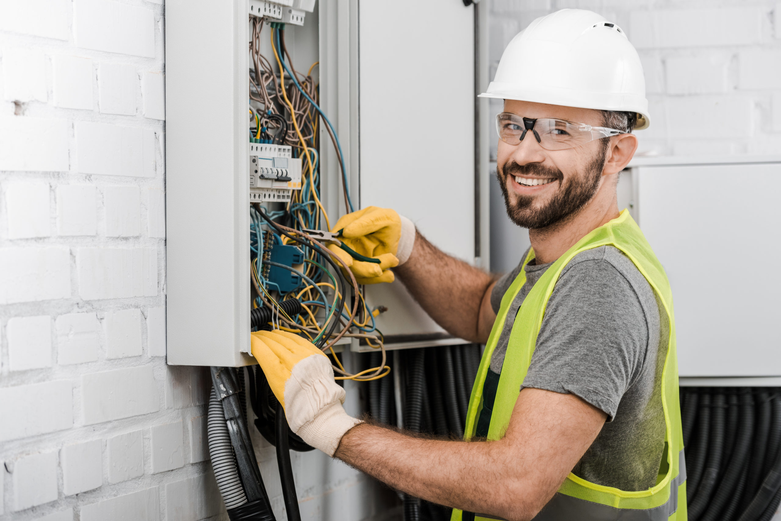 Licensed electrician in Richmond IN wearing protective safety gear while repairing electrical wiring